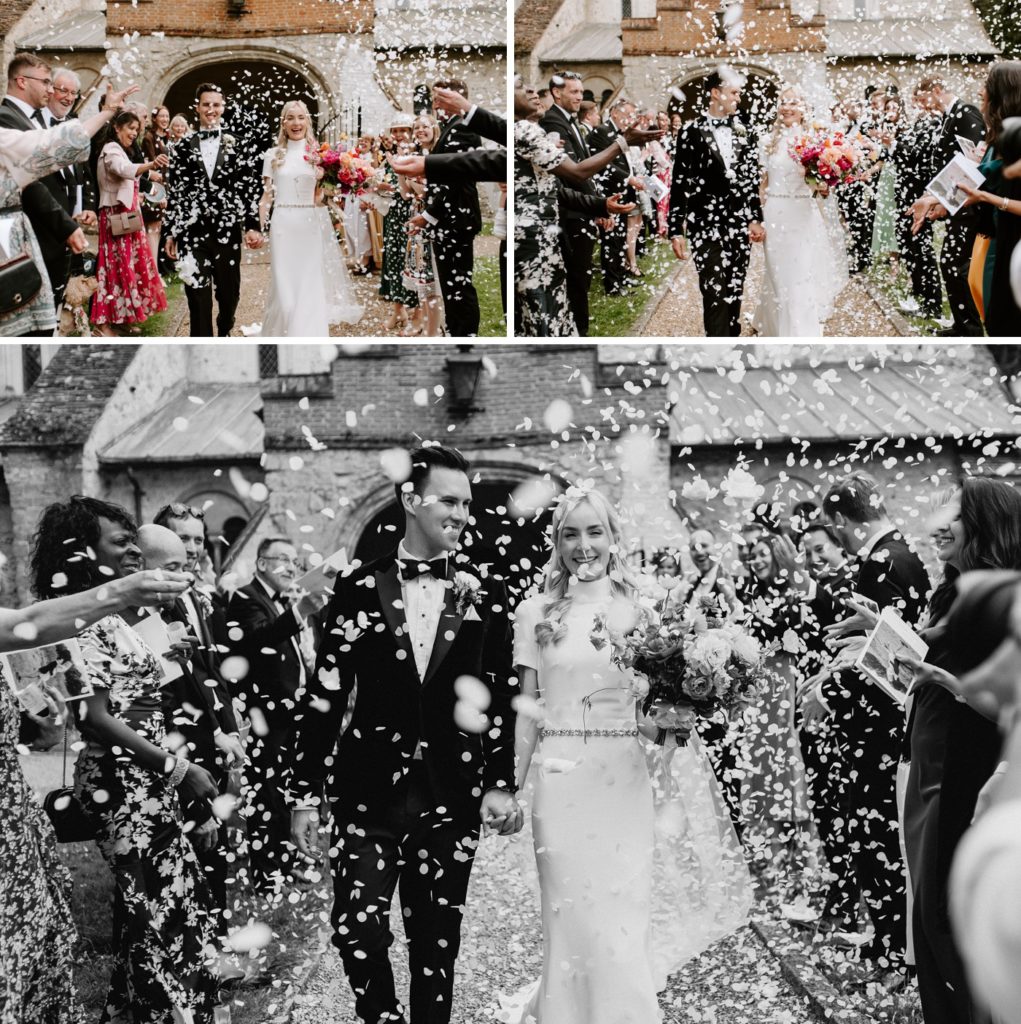 bride and groom walking out of church with white confetti