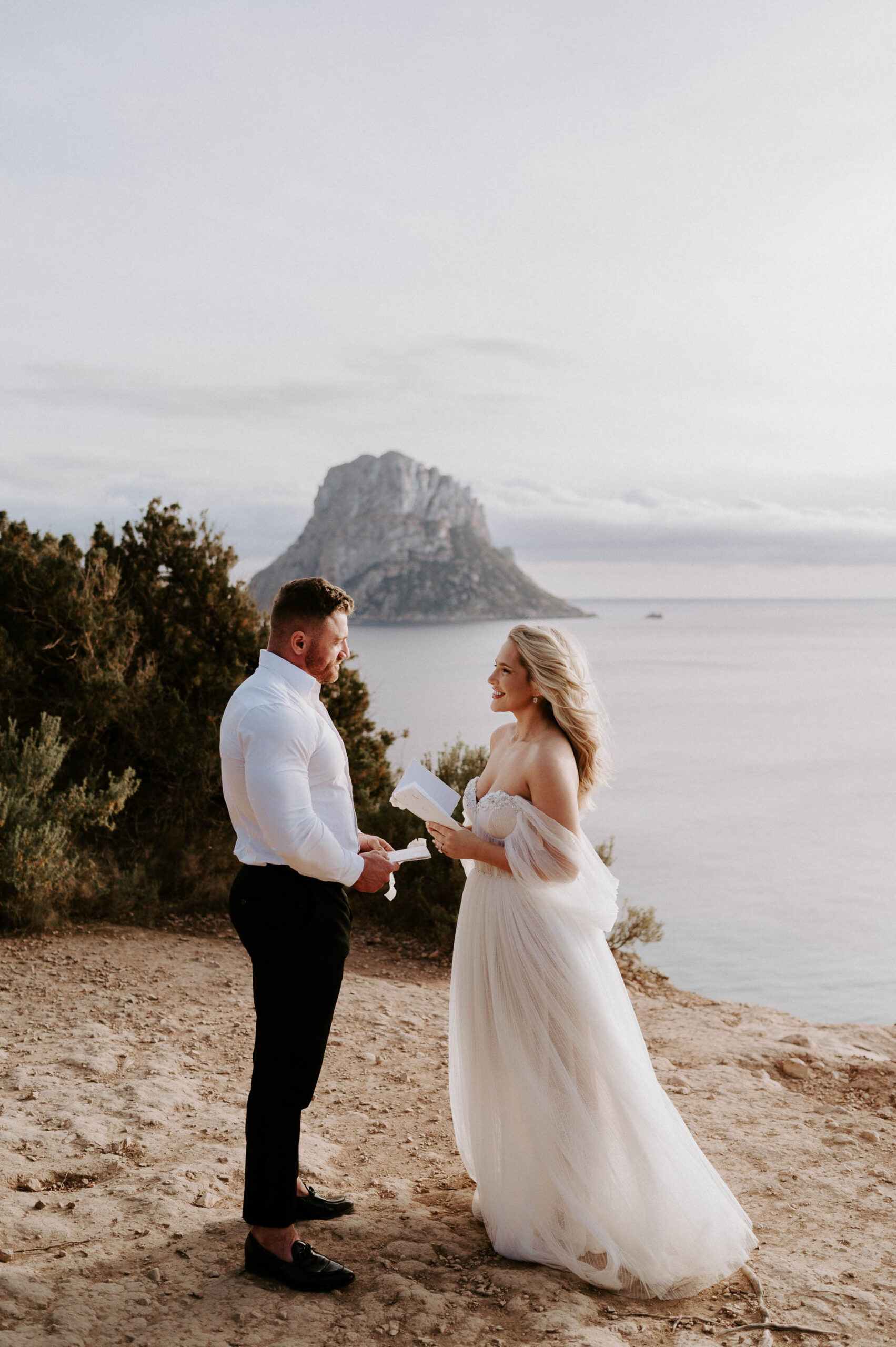 bride and groom reading vows in ibiza at es vedra at sunset