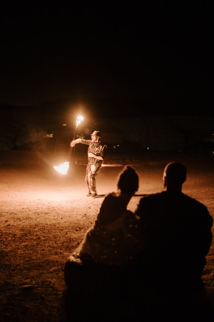 couple watching fire show in marrakesh desert