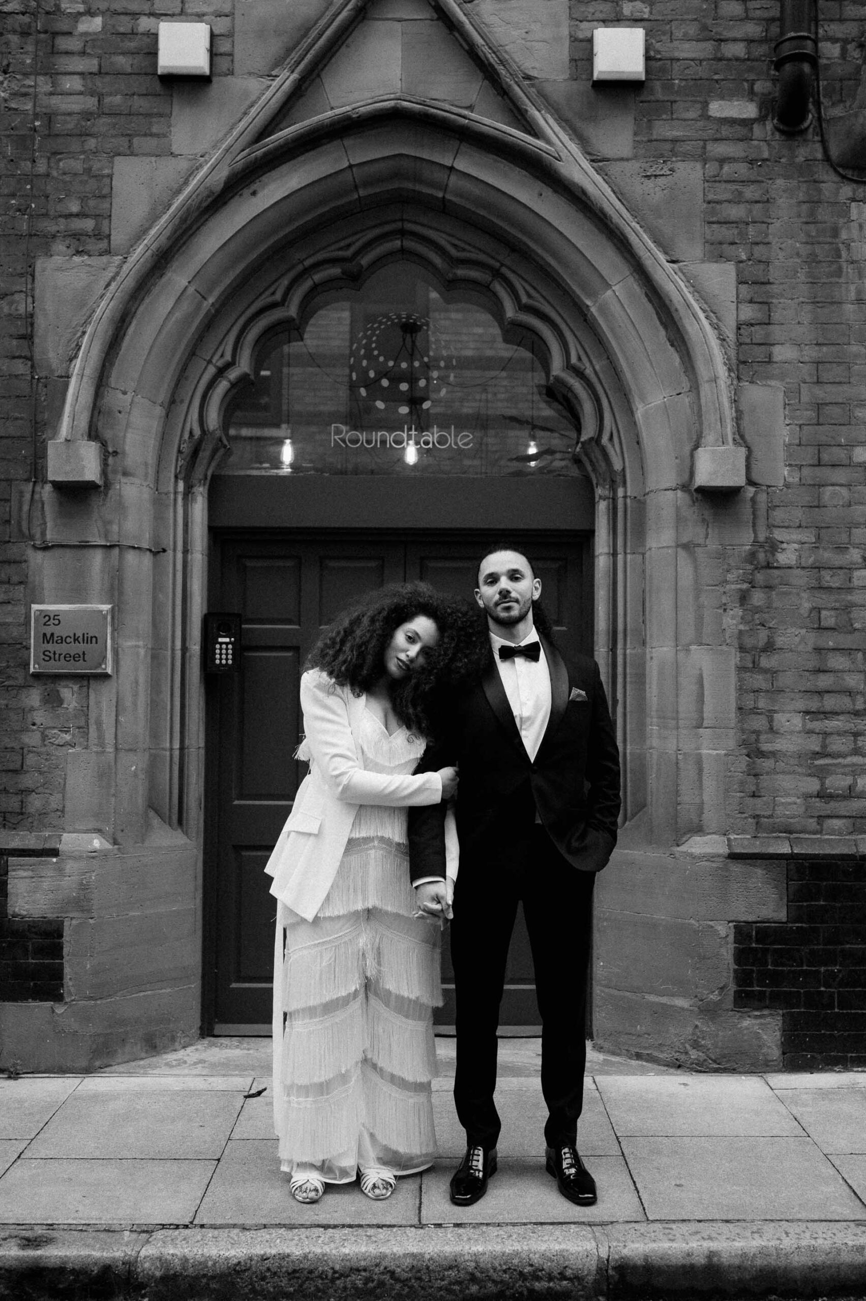 bride and groom standing on streets of london