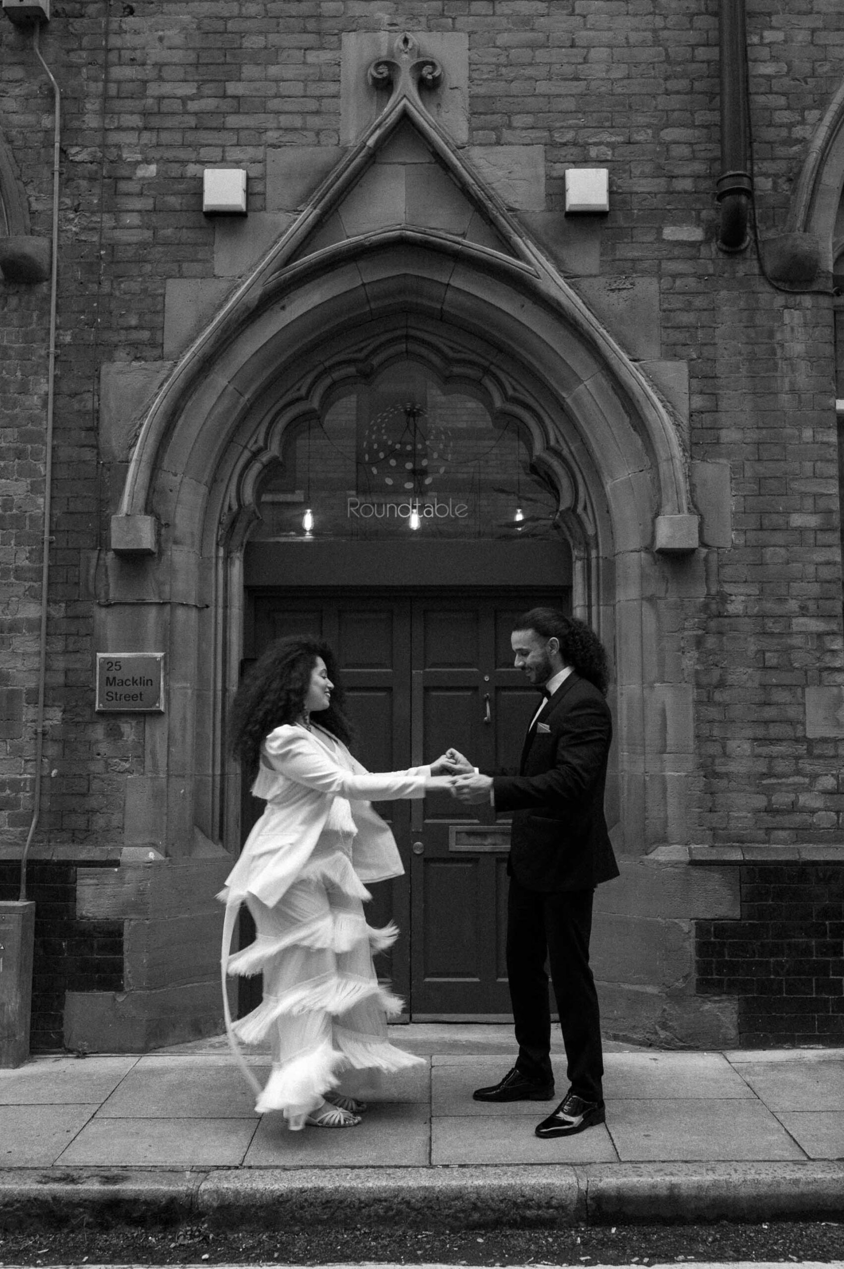 bride and groom dancing on streets of london
