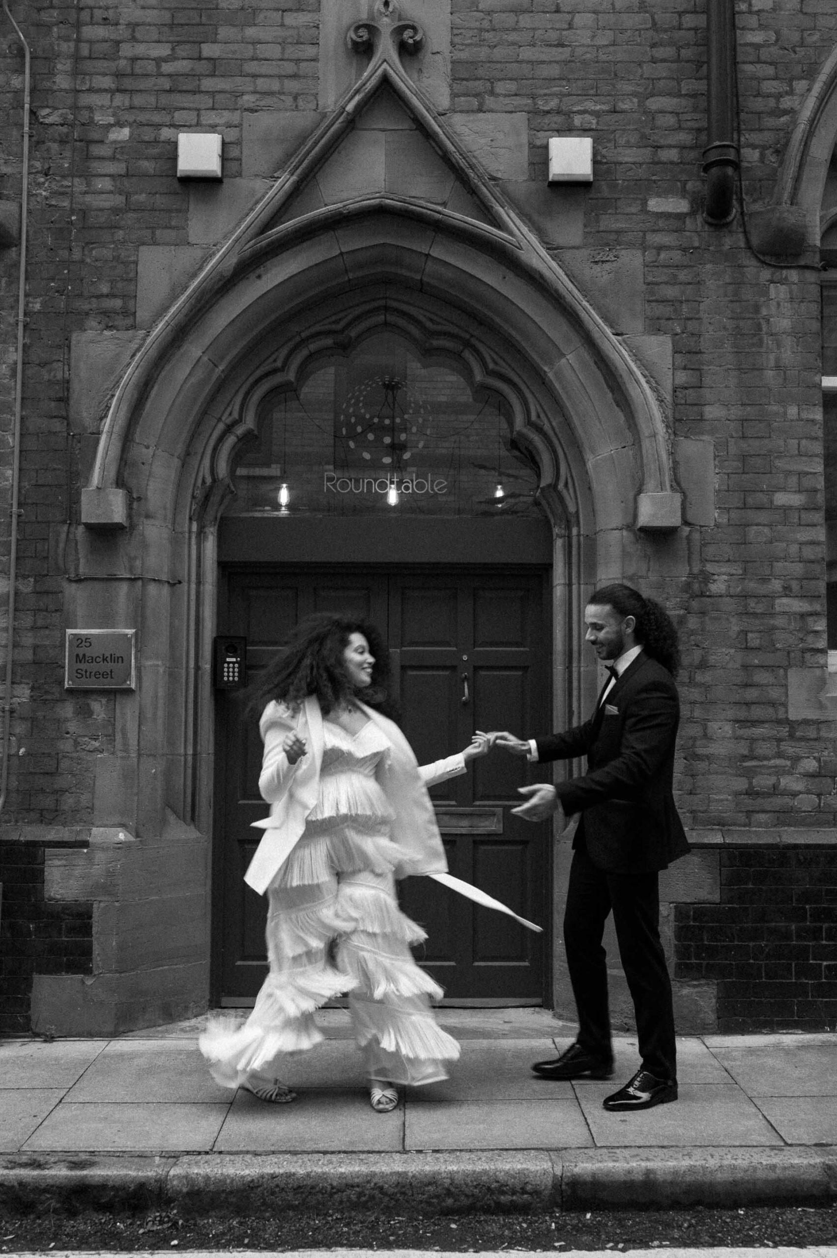 bride and groom dancing on streets of london