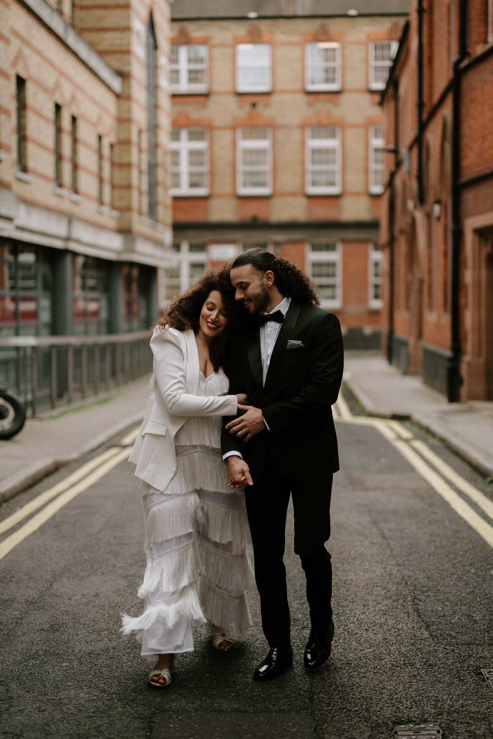 bride and groom walking down streets of london