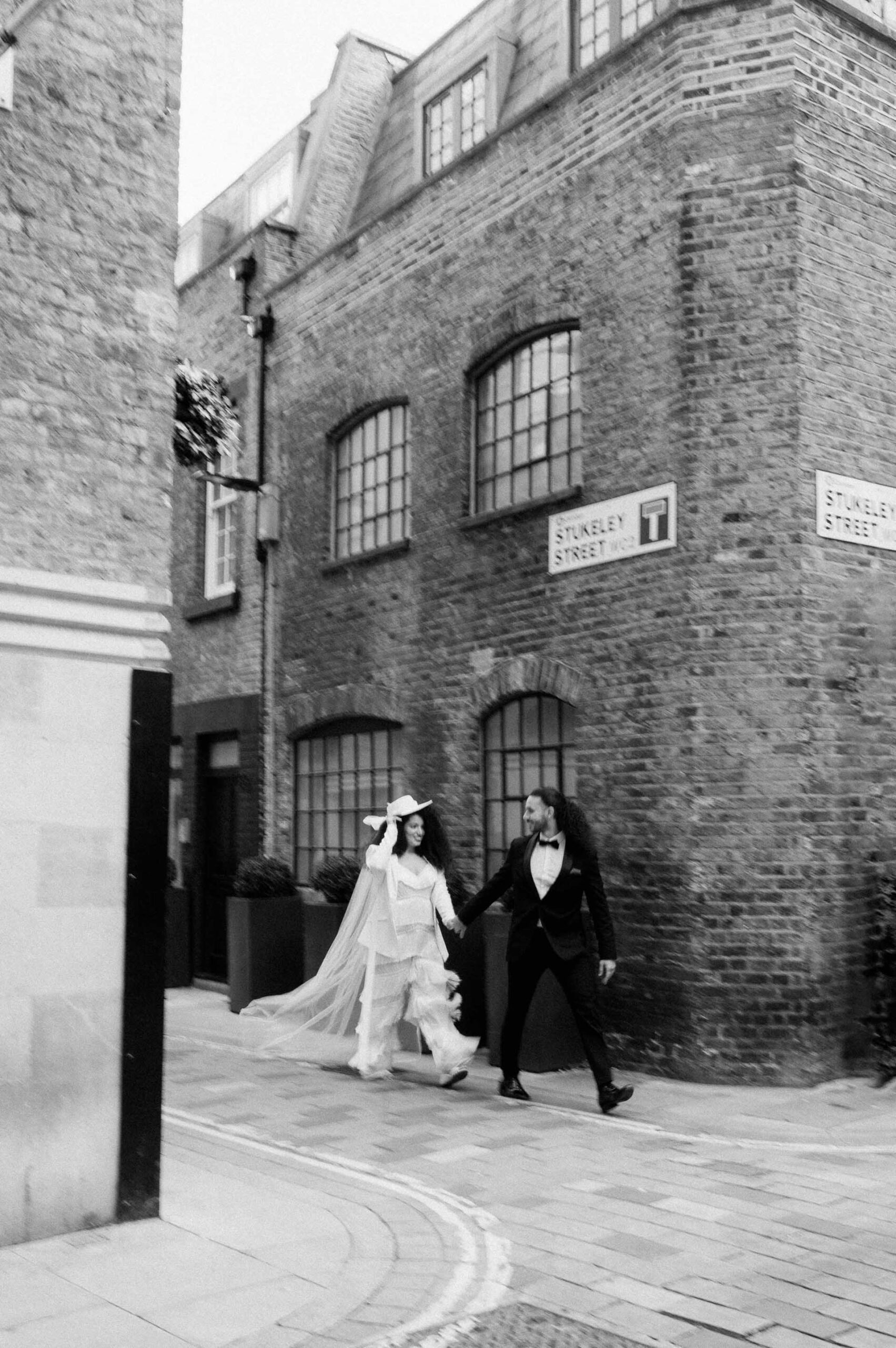 bride and groom walking down street in London