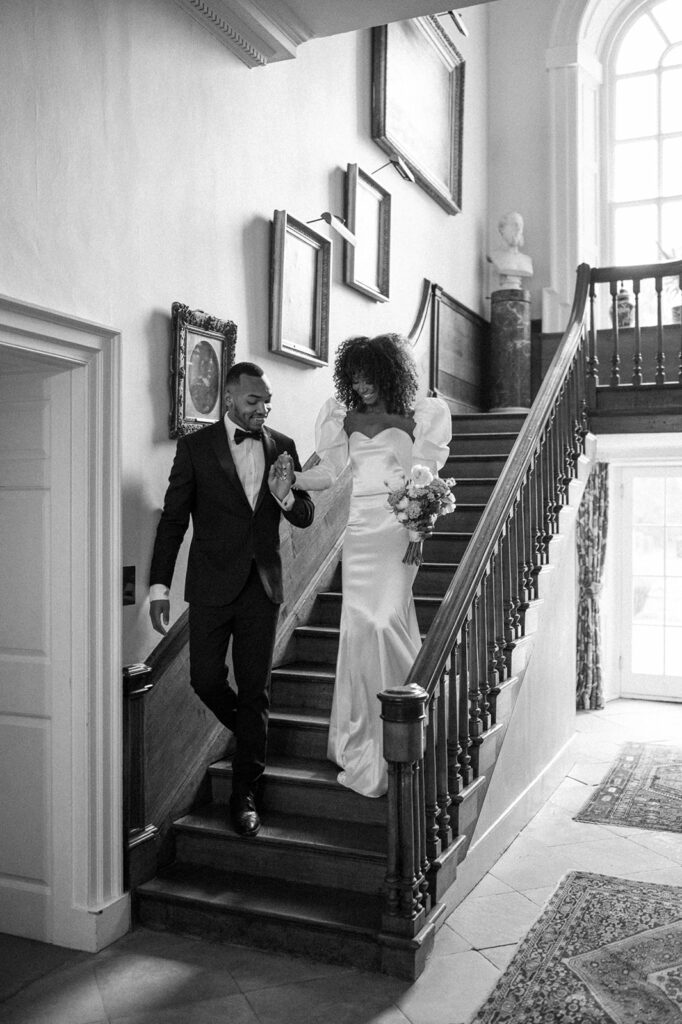 bride and groom walking down stairs in Manor House