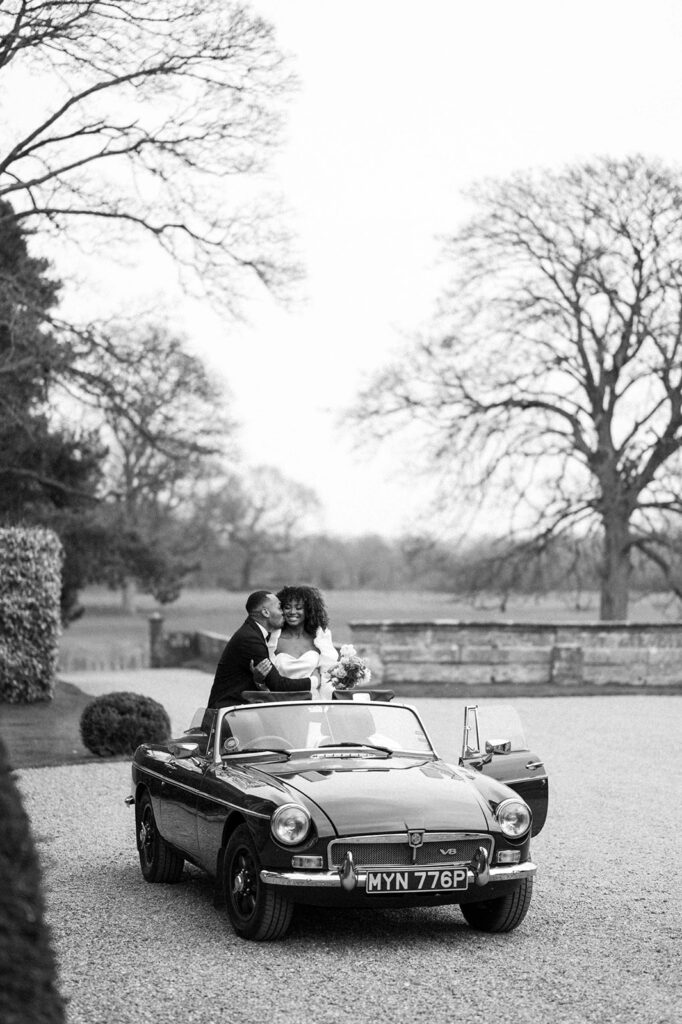 portrait of bride and groom in wedding car