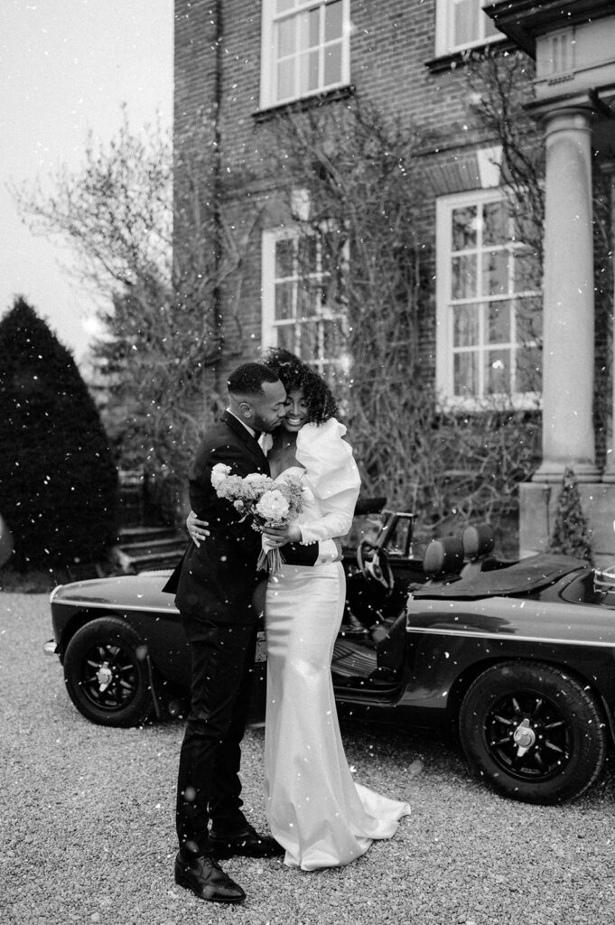 bride and groom outside Iscoyd park wedding venue in the snow