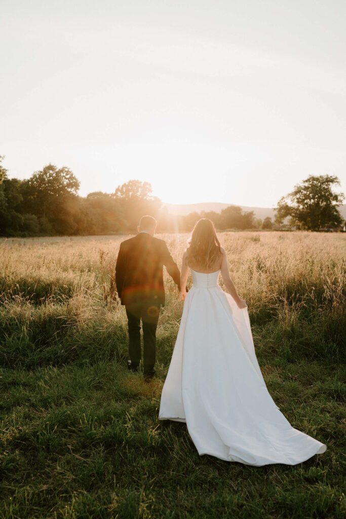 bride and groom at barns and yard at golden hour