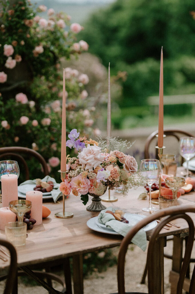 colourful outdoor wedding breakfast set up with spring florals and candlesticks at Euridge manor