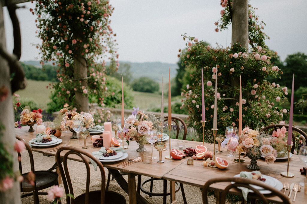 colourful outdoor wedding breakfast set up with spring florals and candlesticks at Euridge manor