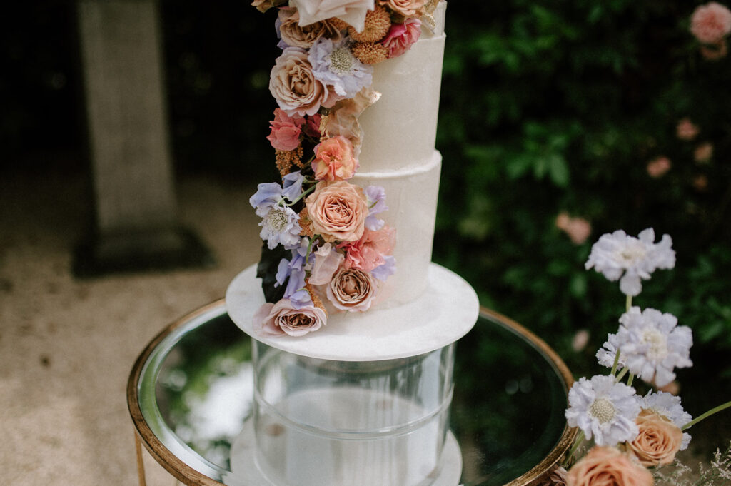 colourful 3 tier wedding cake in gardens of euridge manor
