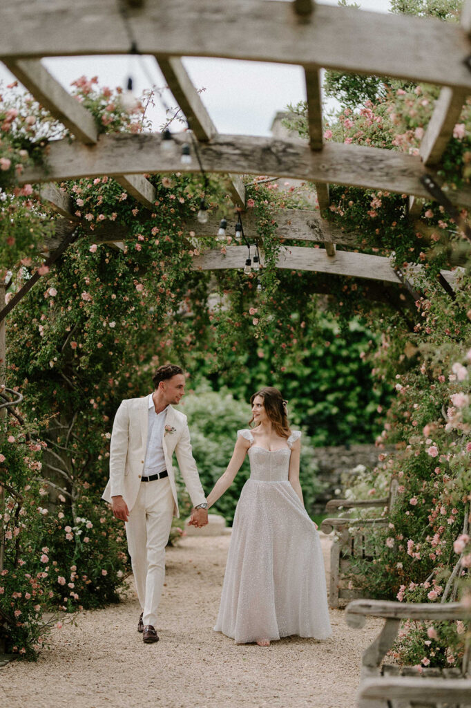 couple walking through rose garden at euridge manor