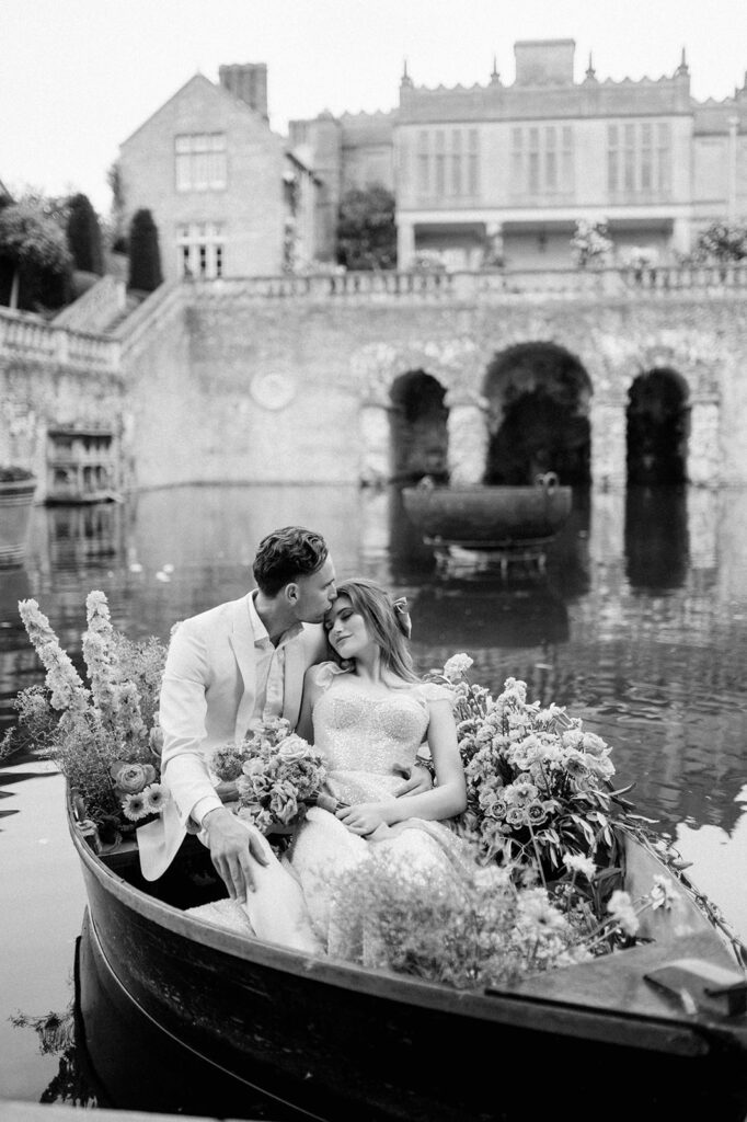 bride and groom in boat on lake at euridge manor