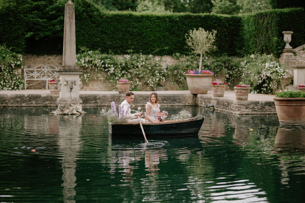 bride and groom rowing on boat on lake at euridge manor
