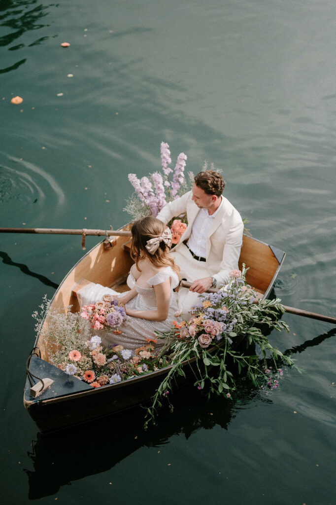 bride and groom in boat on lake at euridge manor