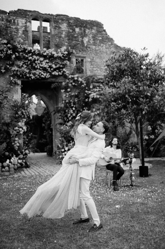 bride and groom having first dance outside in garden at euridge manor