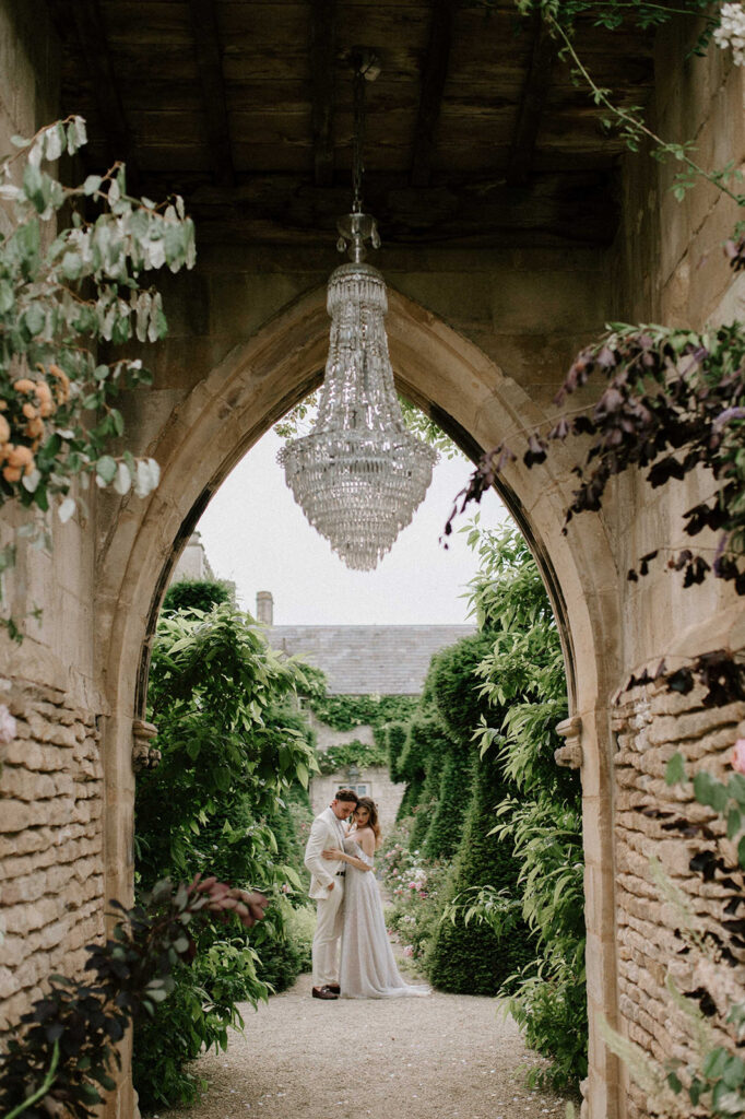 bride and groom walking through gardens at euridge manor