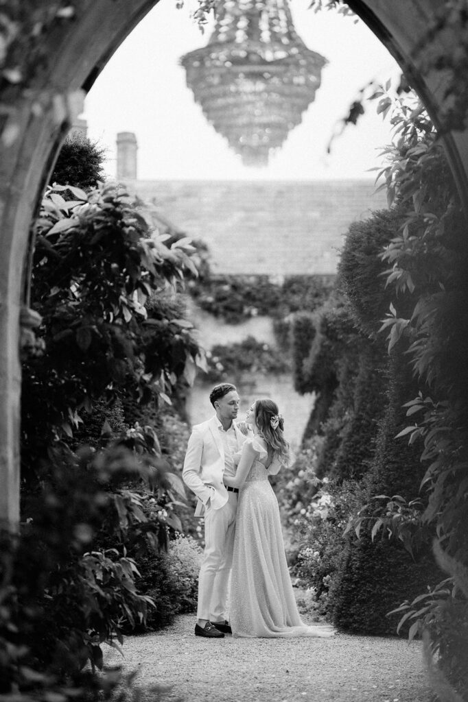 bride and groom walking through gardens at euridge manor