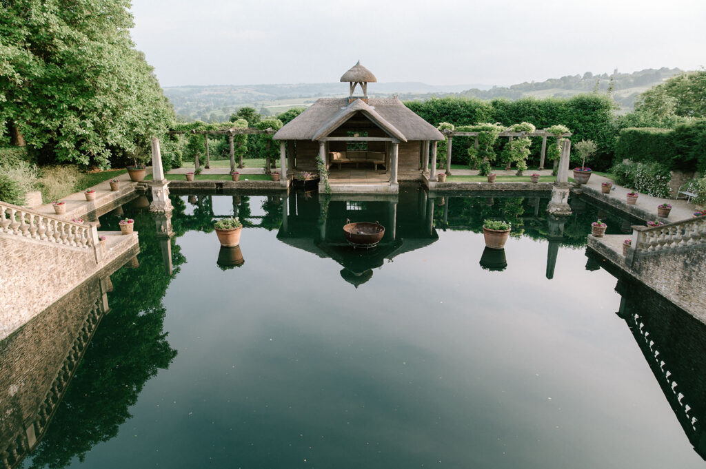 euridge manor boathouse with lake and views of Cotswolds rolling hills