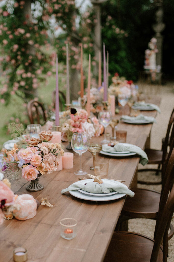 colourful outdoor wedding breakfast set up in gardens of Euridge Manor