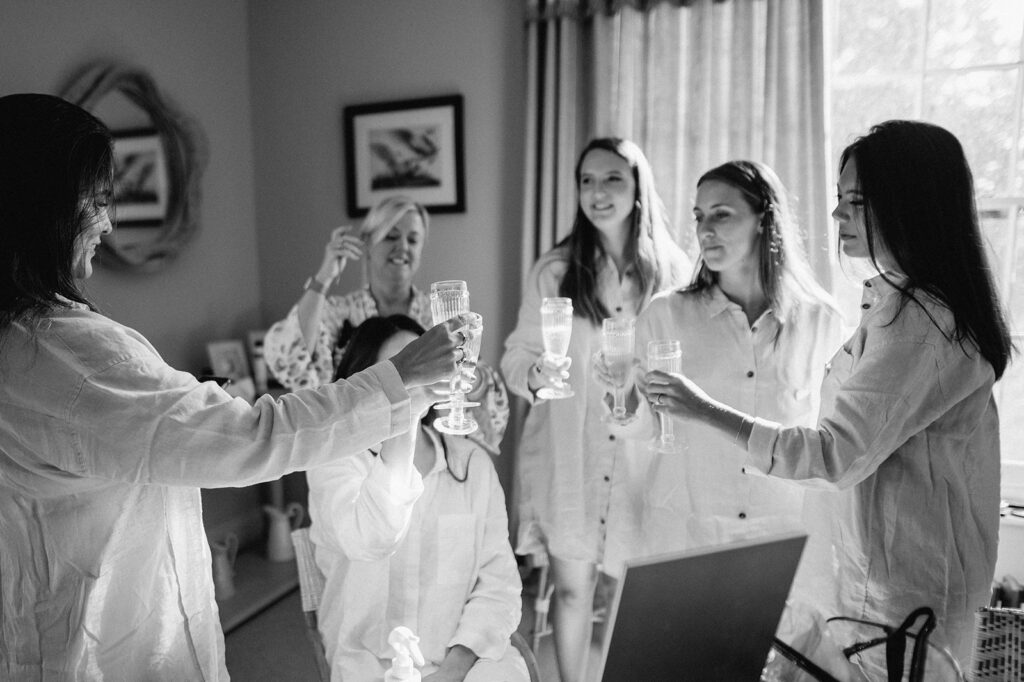 bridesmaids toasting during bridal prep