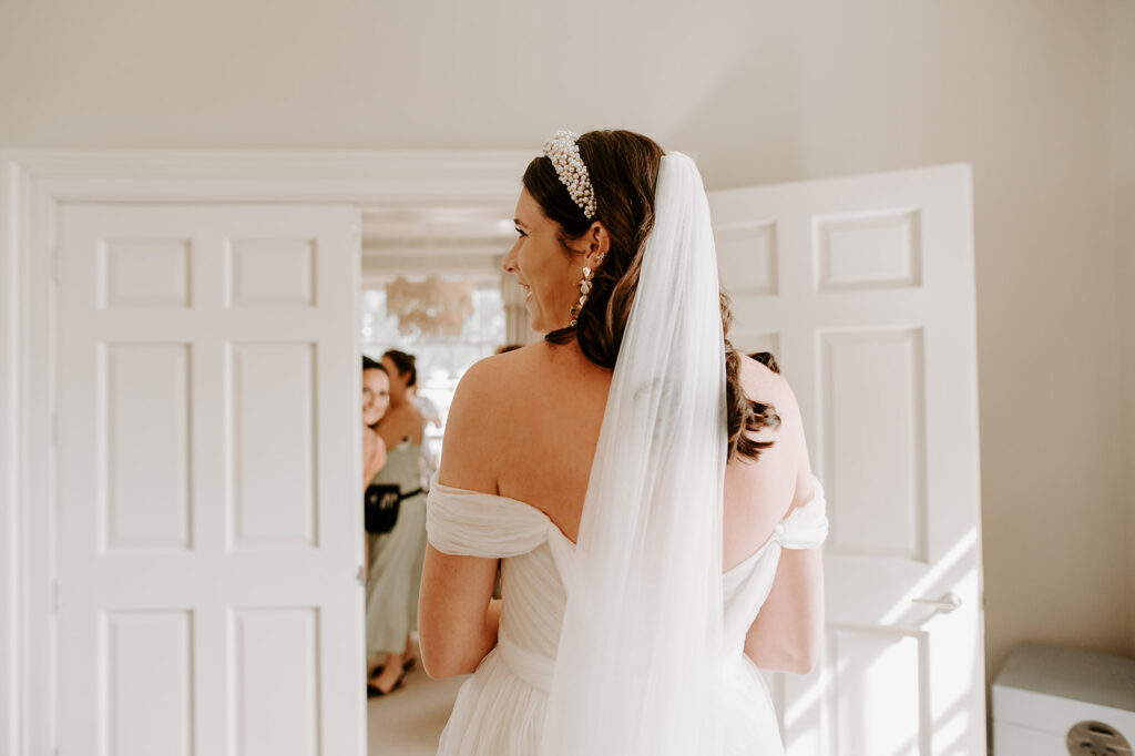 bride smiling from behind