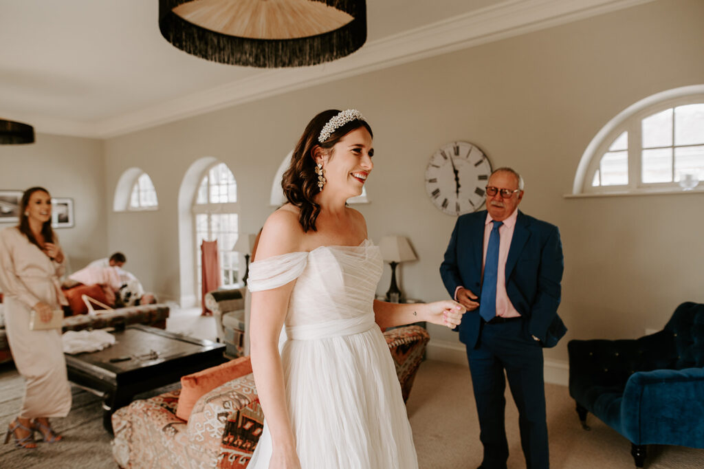 bride smiling with father