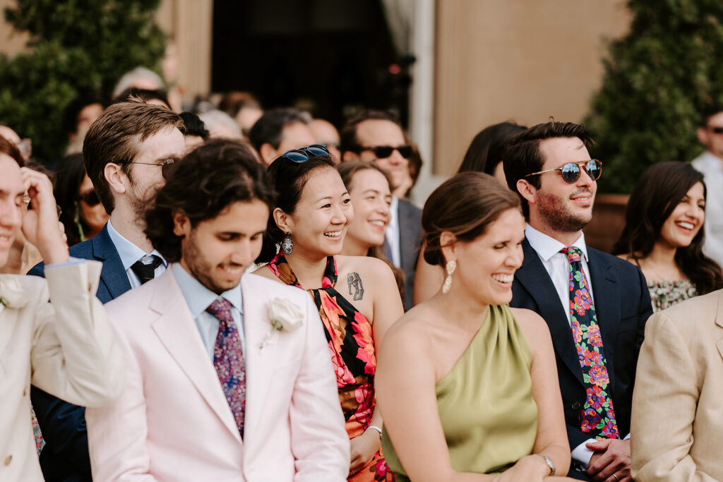 wedding guests laughing during ceremony