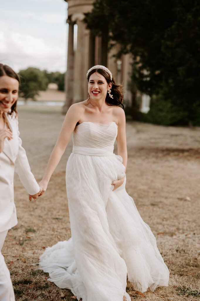 bride laughing holding hands with wife