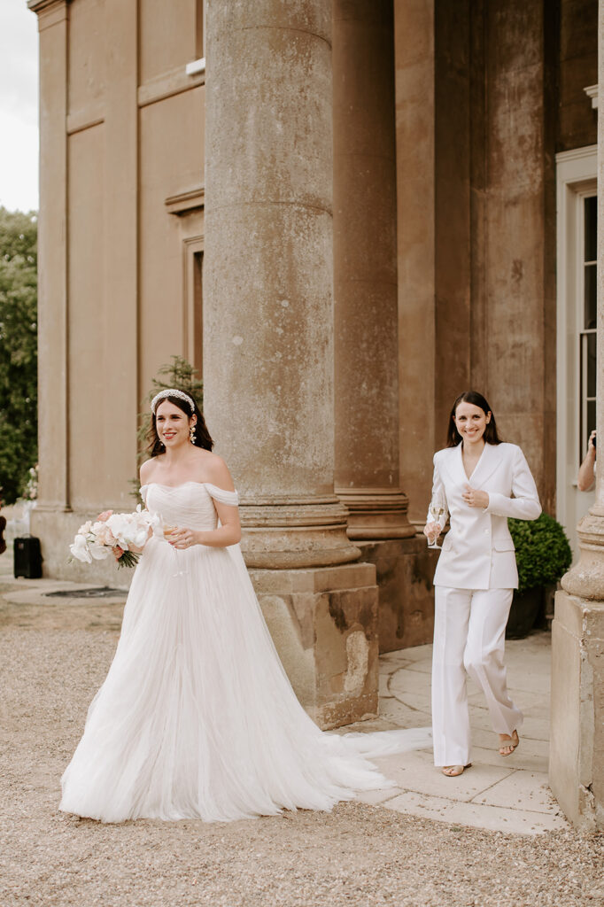 two brides walking out of Sibton park house