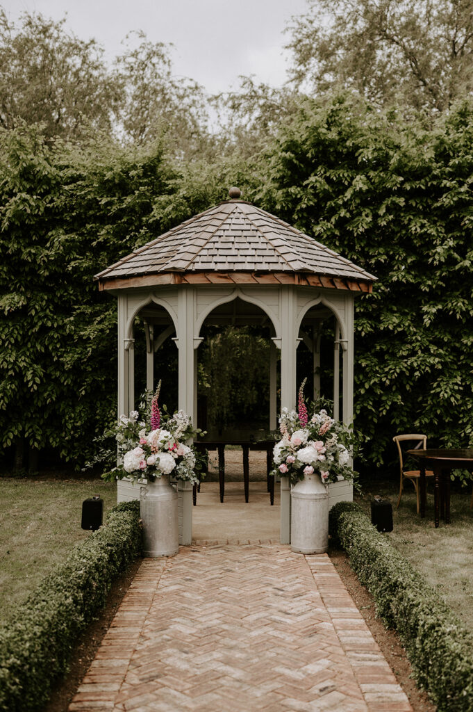 outdoor wedding ceremony set up at retreat east with flower urn arrangment