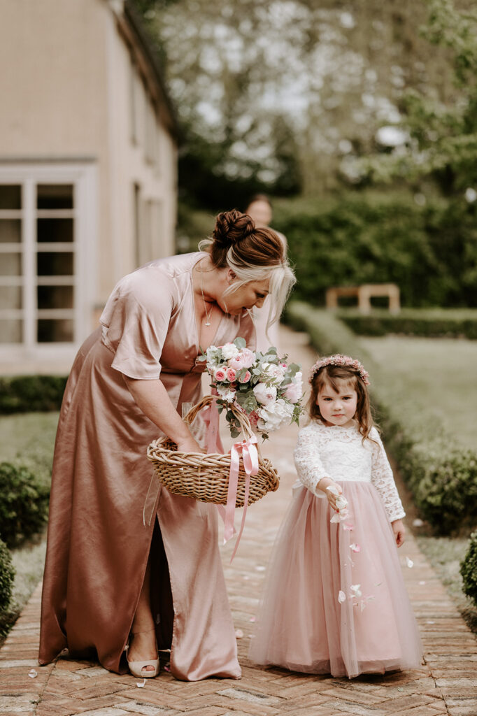 bridesmaid and flower girl walking down aisle at retreat east
