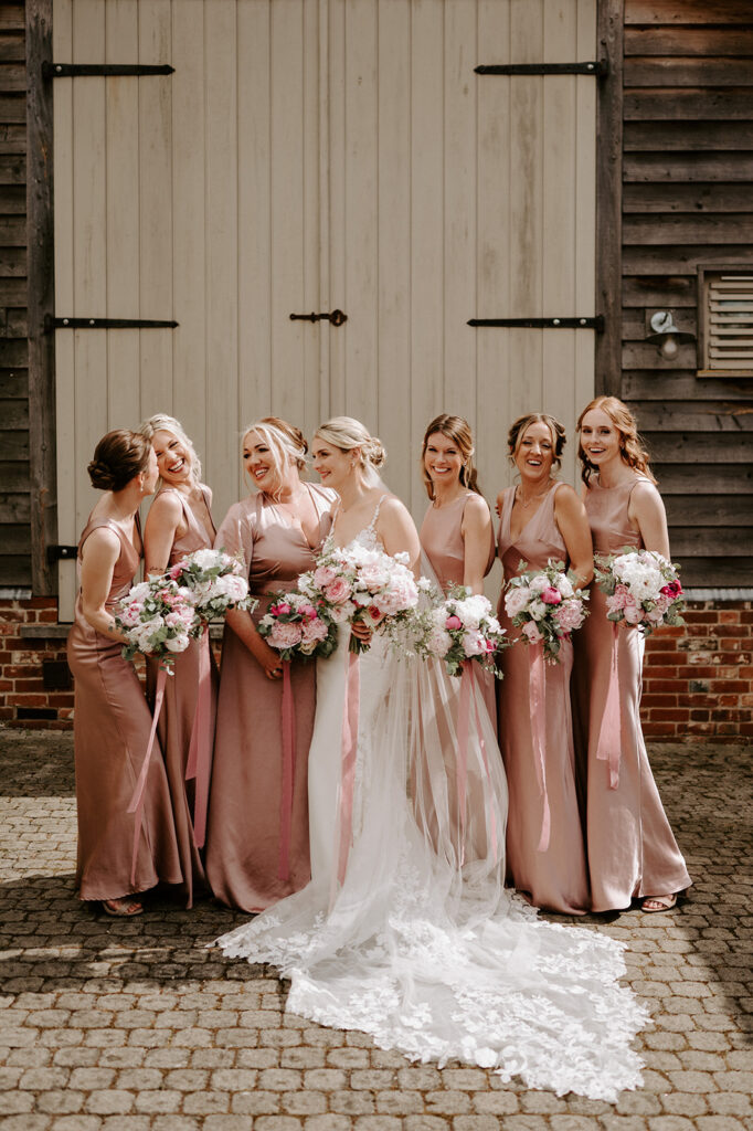 bride wearing Martina liana dress with bridesmaids and peony bouquets at retreat east