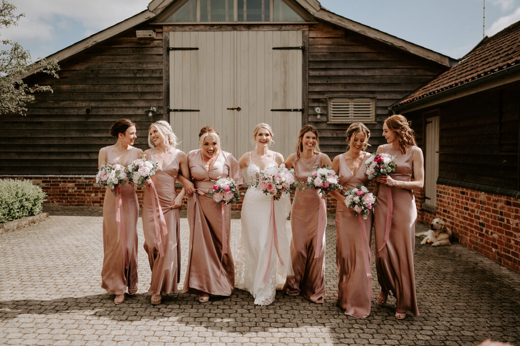 bridesmaids in pink with pink peony bouquets at retreat east