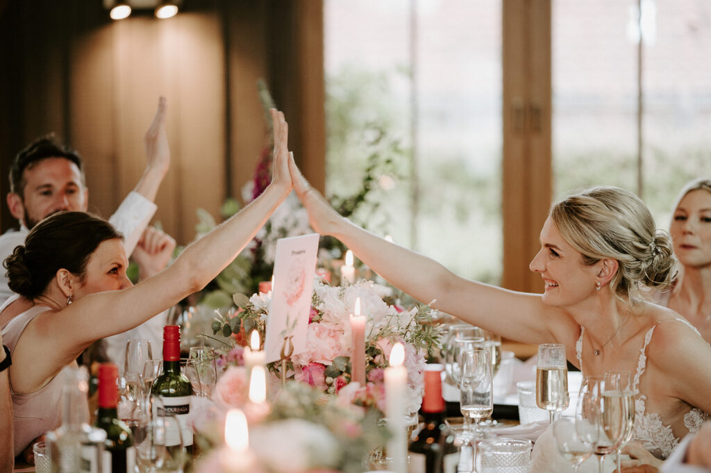 bride high fiving guest at wedding at retreat east