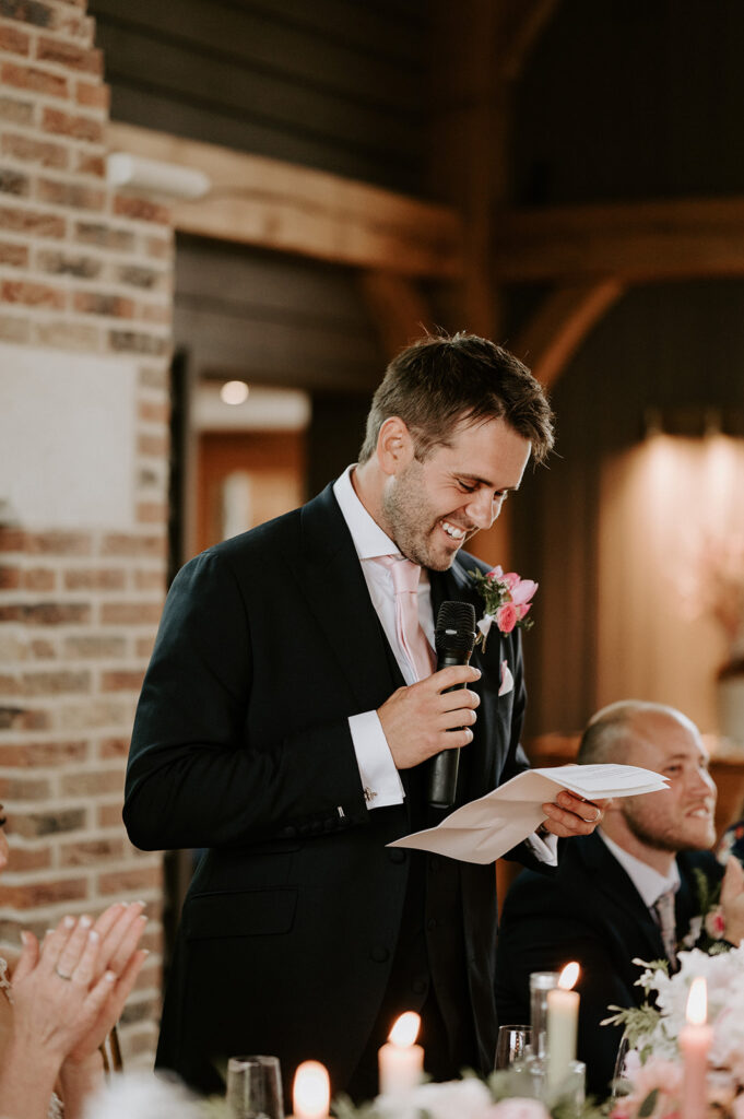 groom giving speech in the great barn at retreat east