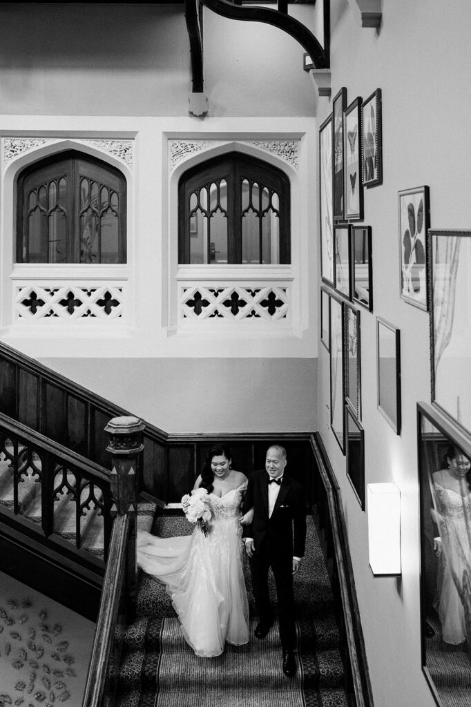bride walking down stairs at tortworth court for ceremony