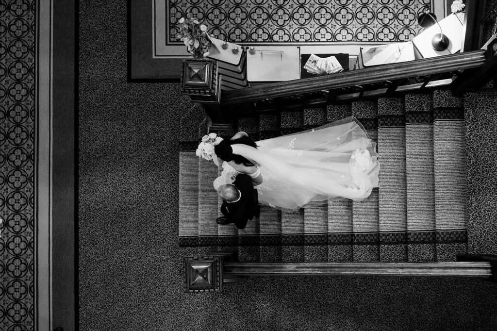 bride walking down stairs at tortworth court for ceremony