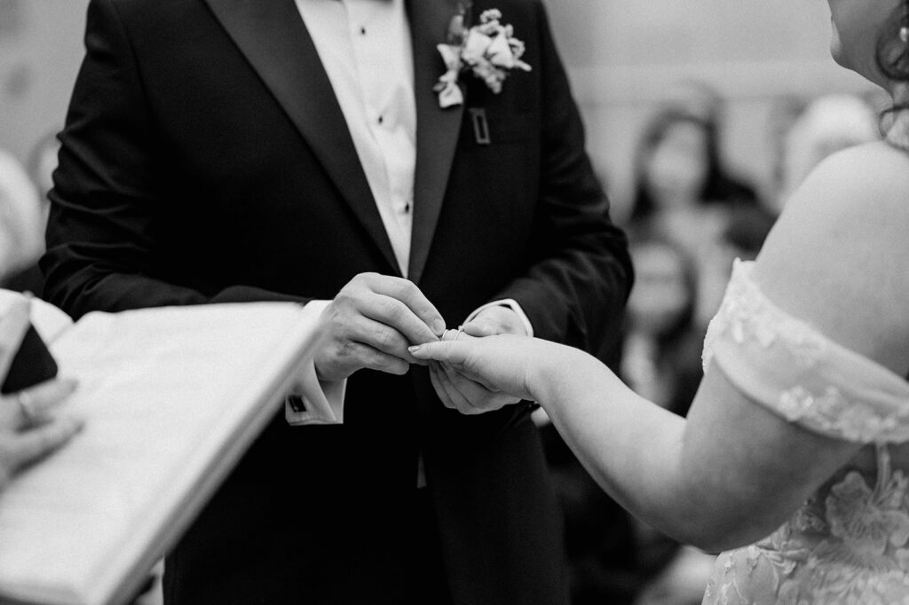 bride and groom exchanging rings at tortworth court