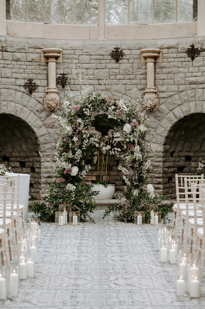 floral arch with greens, neutrals and blush pink