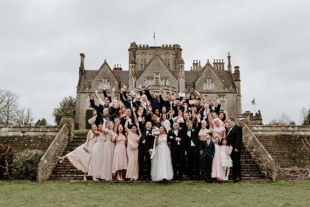 whole wedding group shot on steps at tortworth court 