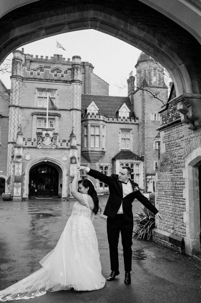 bride and groom dancing in the rain at tortworth court