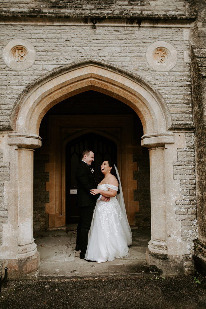 bride and groom in arch at tortworth court