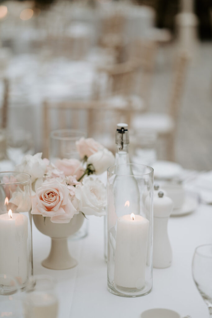 reception table details with blush pink florals and candles