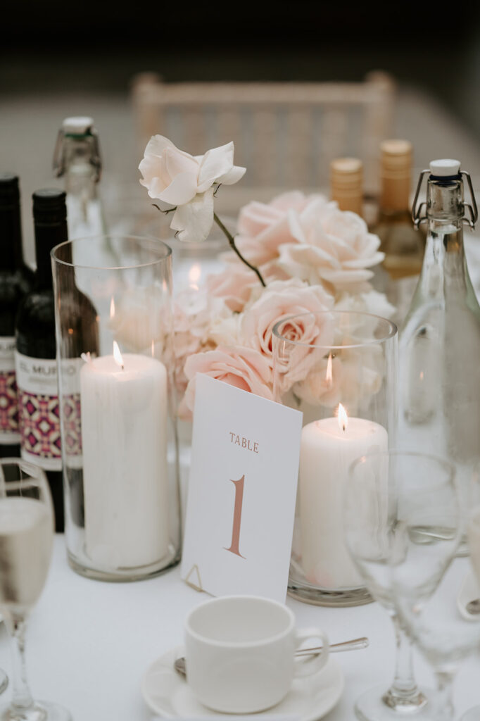 candles and blush pink florals on table