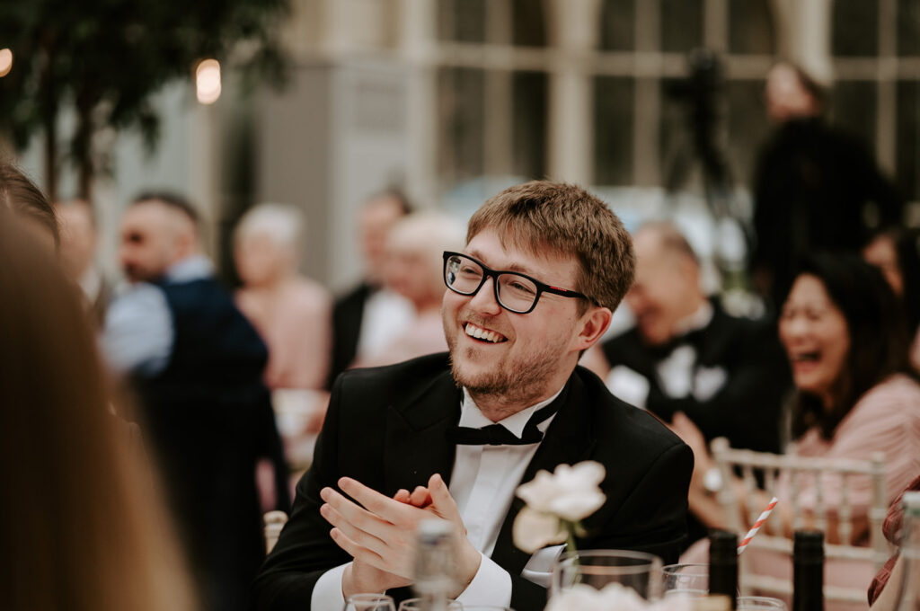 guests laughing at wedding speeches 