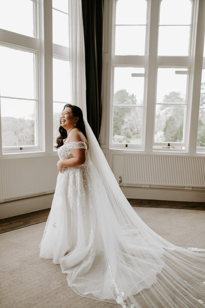 bride by window at tortworth court