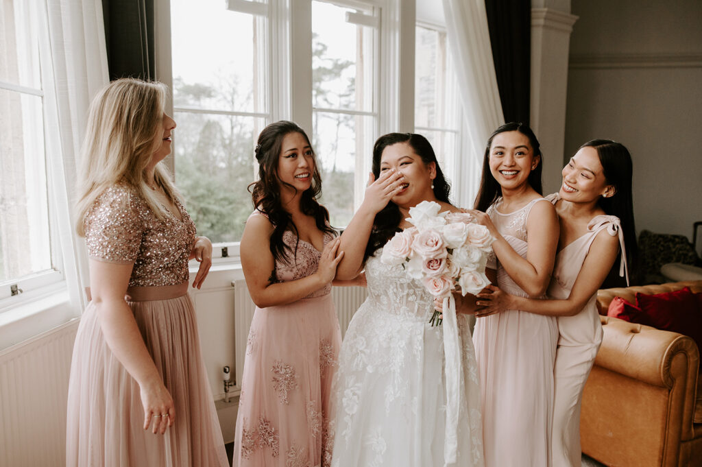bridesmaids in blush pink with bride at tortworth court