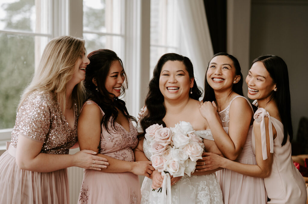 bridesmaids in blush pink with bride at tortworth court