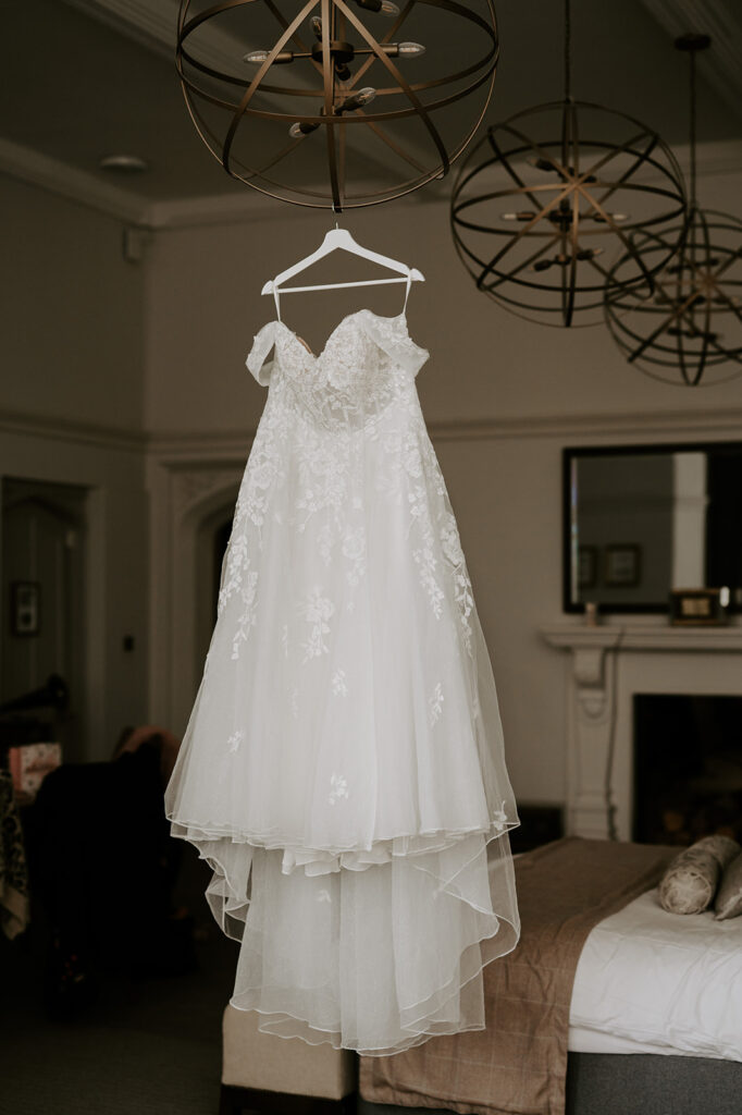 wedding dress hanging in bridal suite at tortworth court
